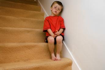 sad boy on staircase